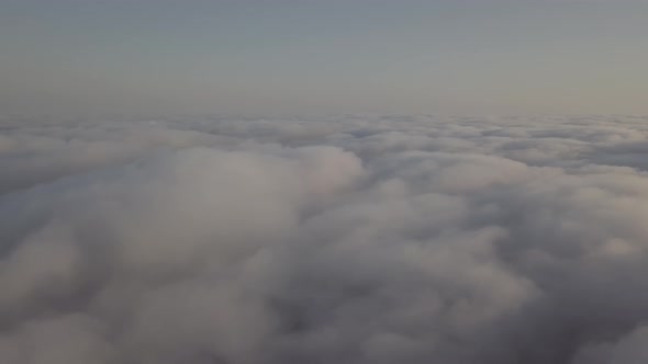 View From a Drone on a Sea of Clouds to the Horizon at Dawn alt