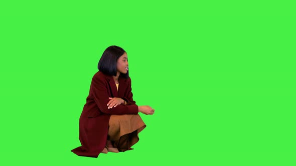 Pretty African Girl Playing with Her Dog Papillon on a Green Screen Chroma Key
