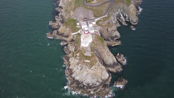 Aerial View Of Bailey Lighthouse With Keepers House On Peninsula At Howth, Dublin, Ireland. alt