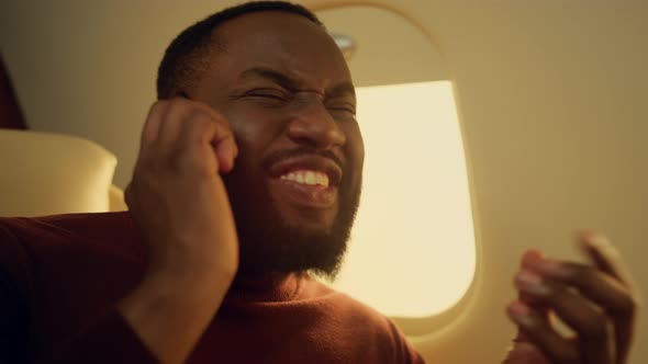 Joyful Man Calling Friend in Airplane Closeup alt
