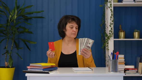 Woman is Holding Credit Card and Money and Choose Cash Money Dollar
