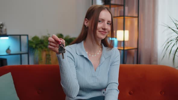 Woman Real Estate Agent Showing the Keys of New Home House Apartment Buying or Renting Property alt