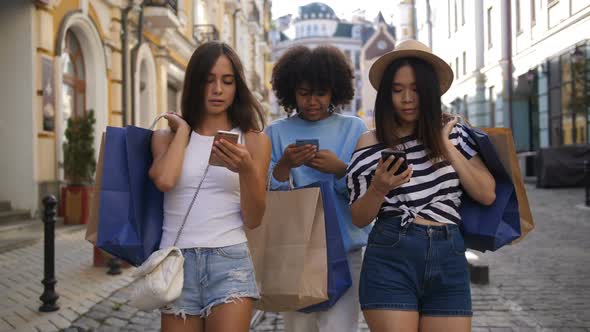 Students Walking with Shopping Bags and Phones