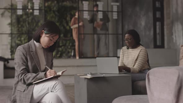 Asian Woman Writing and Posing alt