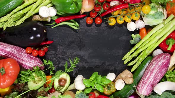 Huge Selection of Fresh Organic Vegetables on a Black Stone Background in the Centre. alt