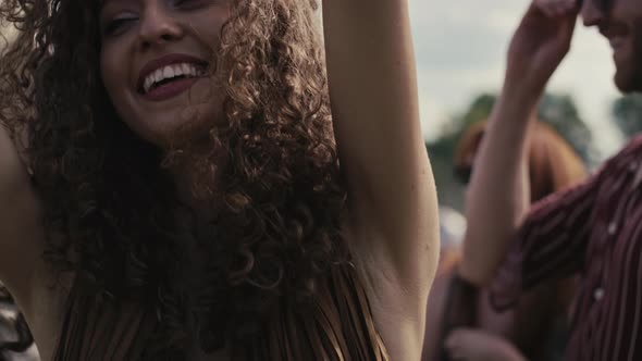 Close up of caucasian woman with curly hair dancing on music festival. Shot with RED helium camera i alt