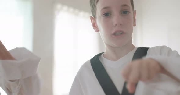 Slow motion footage of young kids practicing martial arts alt