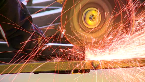 Sparks fly off a grinder in a factory