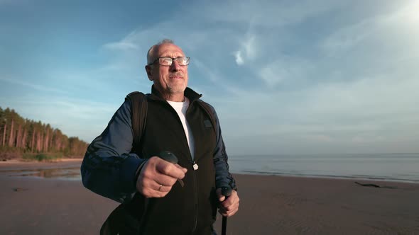 Smiling 70s Aged Man Walking Stick Outdoor Sport Activity Healthy Lifestyle at Sea Beach Sunset alt