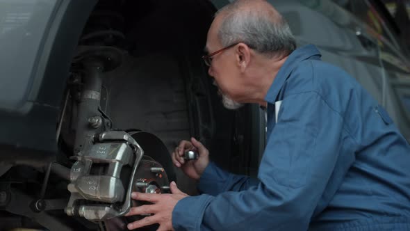 Wheel automobile technician man maintenance, Male mechanic checking and repair car garage service. alt