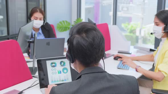 Group of Asian team business people working and meeting in office with new normal social distancing alt