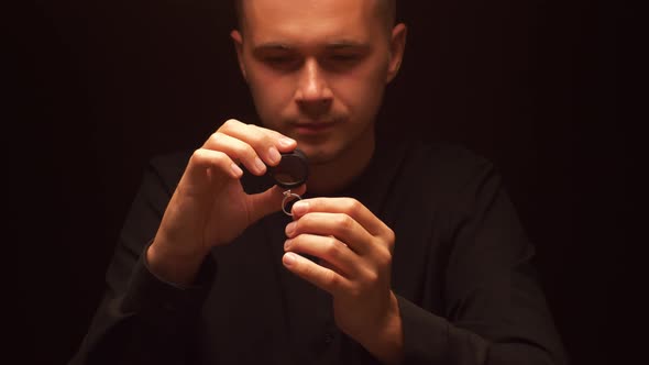 Man Examines Diamond in Ring