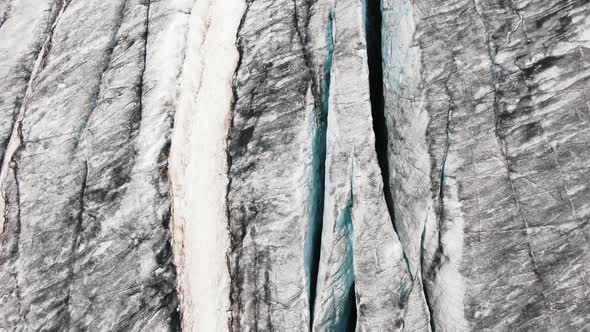 A Fascinating Aerial View of the Deep Cracks of the Glacier and the Lava Fields of a Large Volcano alt