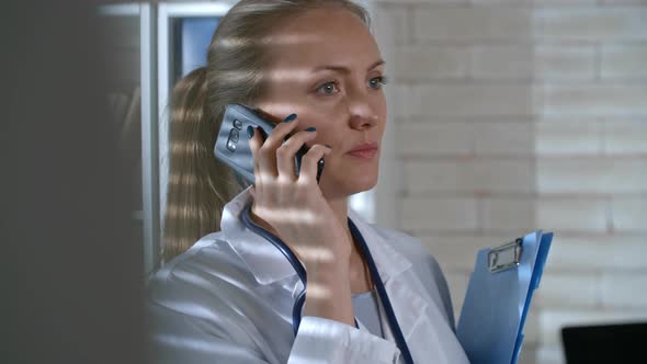 Female Doctor Talking on Phone alt