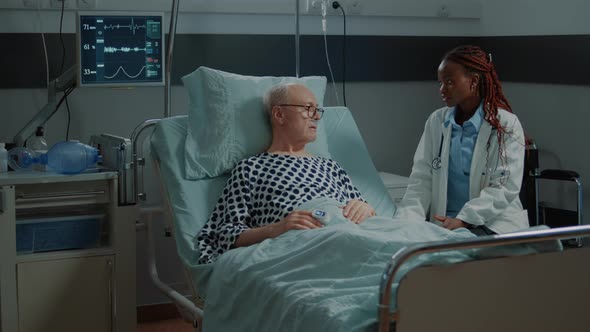 African American Doctor Talking to Sick Elder Patient alt