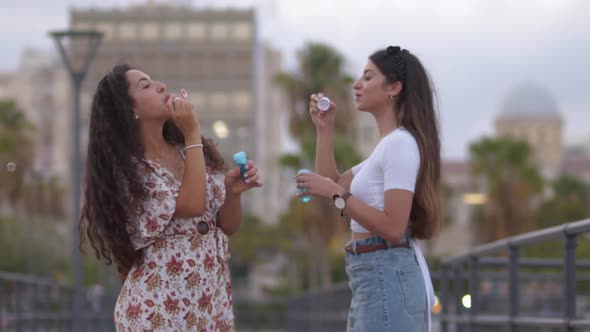 Young Multiethnic Women Having Fun Blowing Bubbles Together Slow Motion