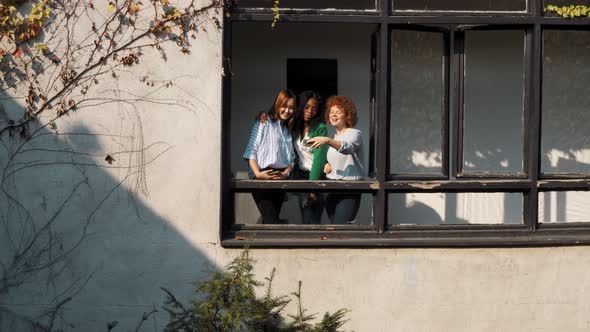 Students taking a selfie at open window