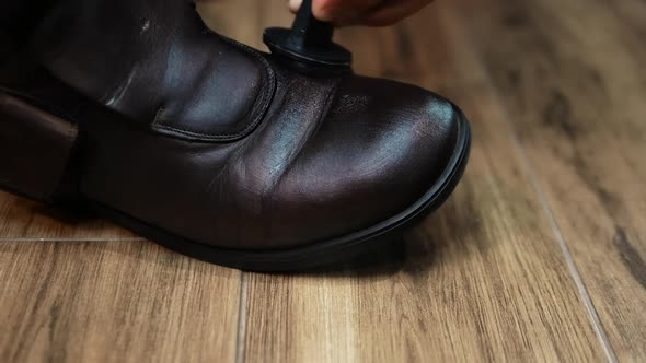Caring For Leather Men's Shoes, Apply Brown Cream On Old Worn Out Shoes,  A Shoemaker Wipes Shoes. alt