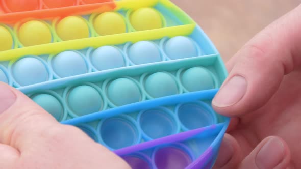 Closeup Shot of a Person Using a Pop It Toy alt