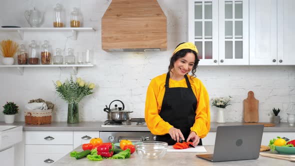 Smiling Woman Slices Tomato Tells Listen Chef Study Online Video Call Laptop alt