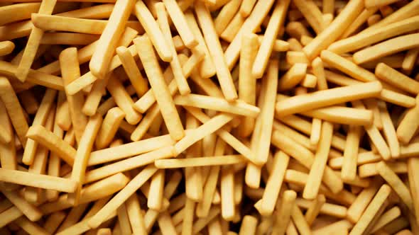 Loopable footage of the endless french fries pile. Fast food. Tasty chips. 4k HD alt
