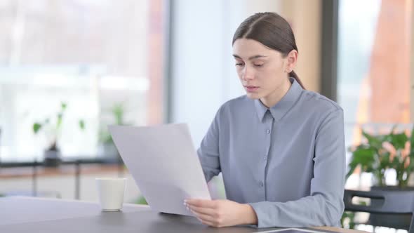 Young Latin Woman Upset By Loss on Documents alt