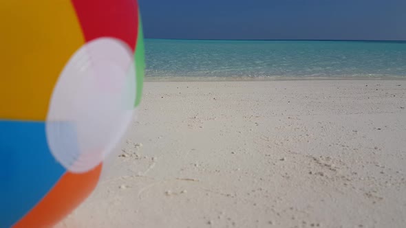 Beautiful flying clean view of a white sandy paradise beach and blue water background in 4K alt