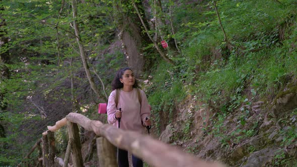 Visiting Natural Reserve Park in Summer Young Woman with Backpack is Discovering Nature alt
