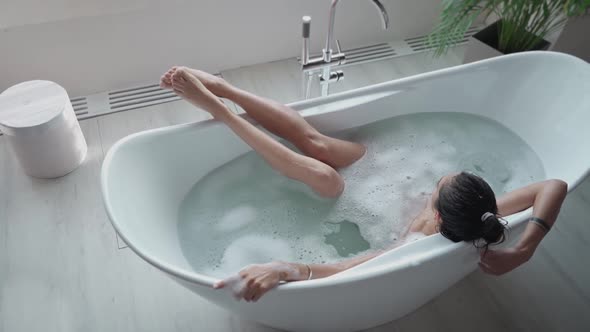 Relaxed Woman Washing Hands in Bath in Slow Motion