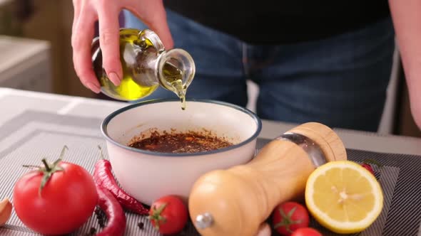 Preparing a Marinade Sauce for Bbq in a Domestic Kitchen  Adding Olive Oil alt