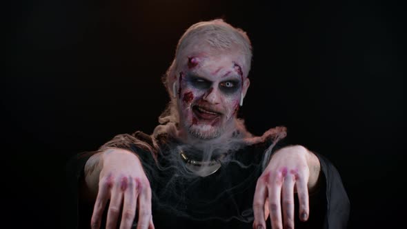 Frightening Man with Halloween Zombie Makeup Wearing Earphones Listening Music Dancing Celebrating alt