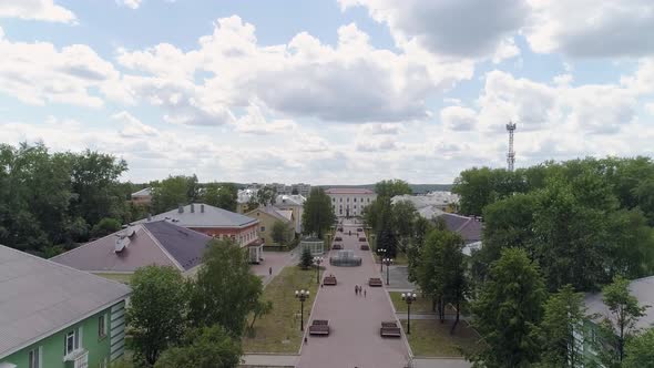 People walks along a beautiful alley in a provincial town. Aerial 01 alt