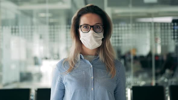 Front View of a Woman in a Safety Mask and Glasses alt