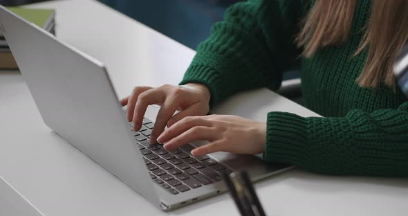 Freelancer Is Working with Notebook Woman Is Typing on Keyboard Closeup View of Hands Manager in alt