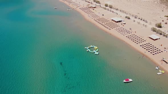 Aerial View Of Tsambika Beach With Inflatable Island At Water Park In Rhodes, Greece. alt