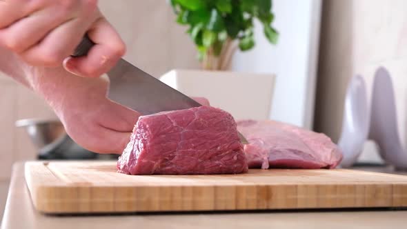 Man Cuts Meat with Knife on Wooden Board Preparation Minced Beef Pork for Cutlets Meatballs Chops