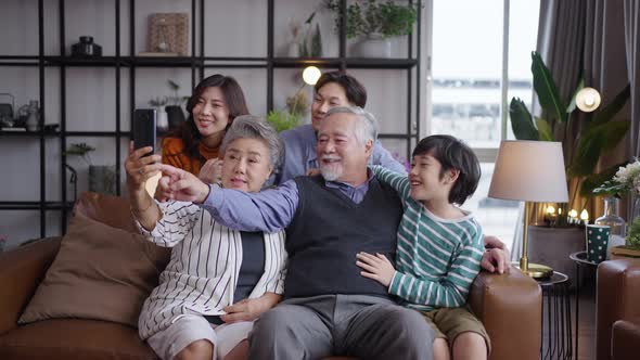 Asian big family taking selfie together at home.