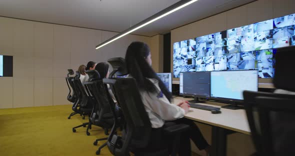 Security Guards Monitoring Modern CCTV Cameras in Surveillance Room alt