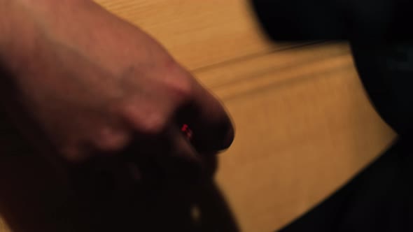 A Musician is Holding a Saz alt