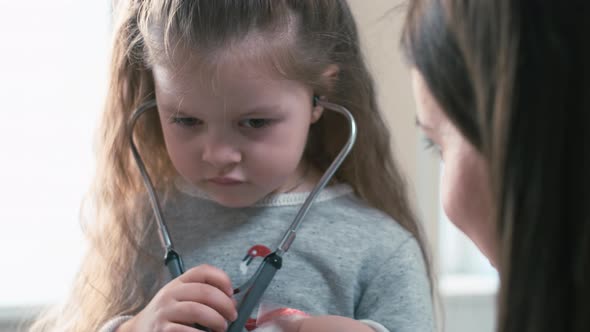 Kid putting stethoscope on