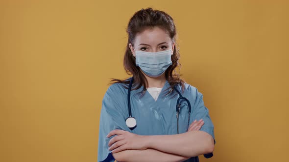 Portrait of Woman Doctor with Arms Crossed Posing Confident Wearing Covid Protection and Stethoscope alt