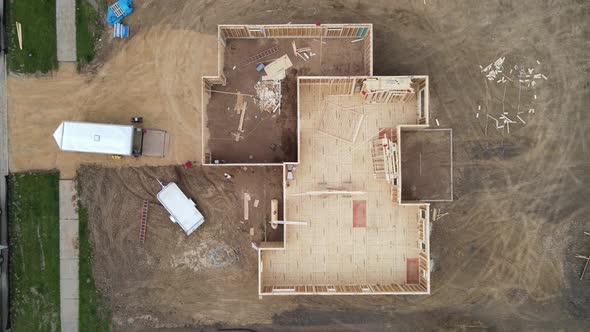 Top down view of new residential home construction site with framing in place with floor boards.