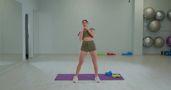 Athletic Brunette Girl Performs Torso Rotation