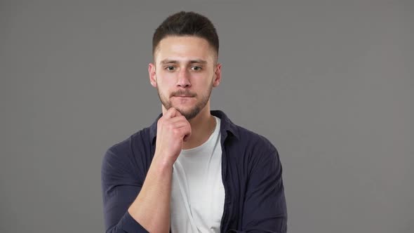Portrait of Smart Guy in Casual Clothing Posing with Doubting Brooding Look While Thinking or alt