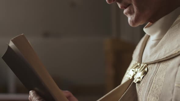 Unrecognizable Old Clergyman Reading Holy Bible alt