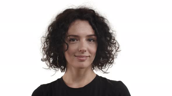 Closeup of Pretty Caucasian Woman with Dark Curly Hairstyle Contemplating Something Beautiful alt
