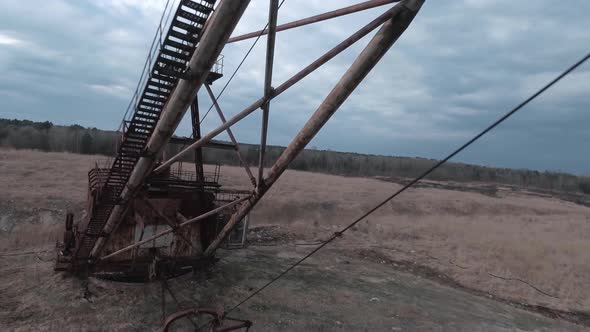 FPV Drone Flies Maneuverable Near Abandoned Walking Excavator alt