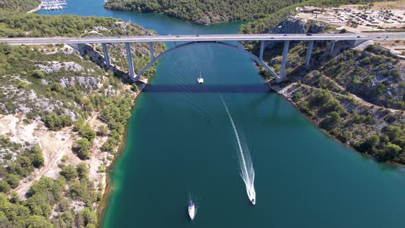 Flying over Krka river, autostrada and arch bridge at summer in Croatia, Europe alt