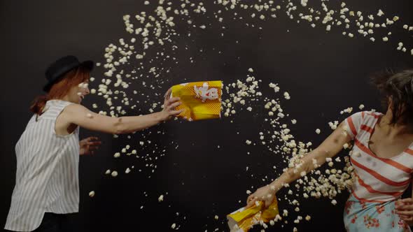 Two girls fighting with popcorn, Ultra Slow Motion alt
