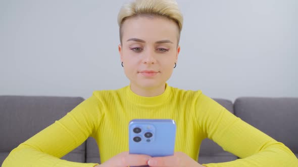 Young woman using mobile phone messenger app for communication online in 4k video alt